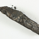 This lump of charcoal is actually one of the oldest known fragments of a biblical text, second only to the Dead Sea Scrolls. (Image: Shay Halevi/Israel Antiquities Authority)
